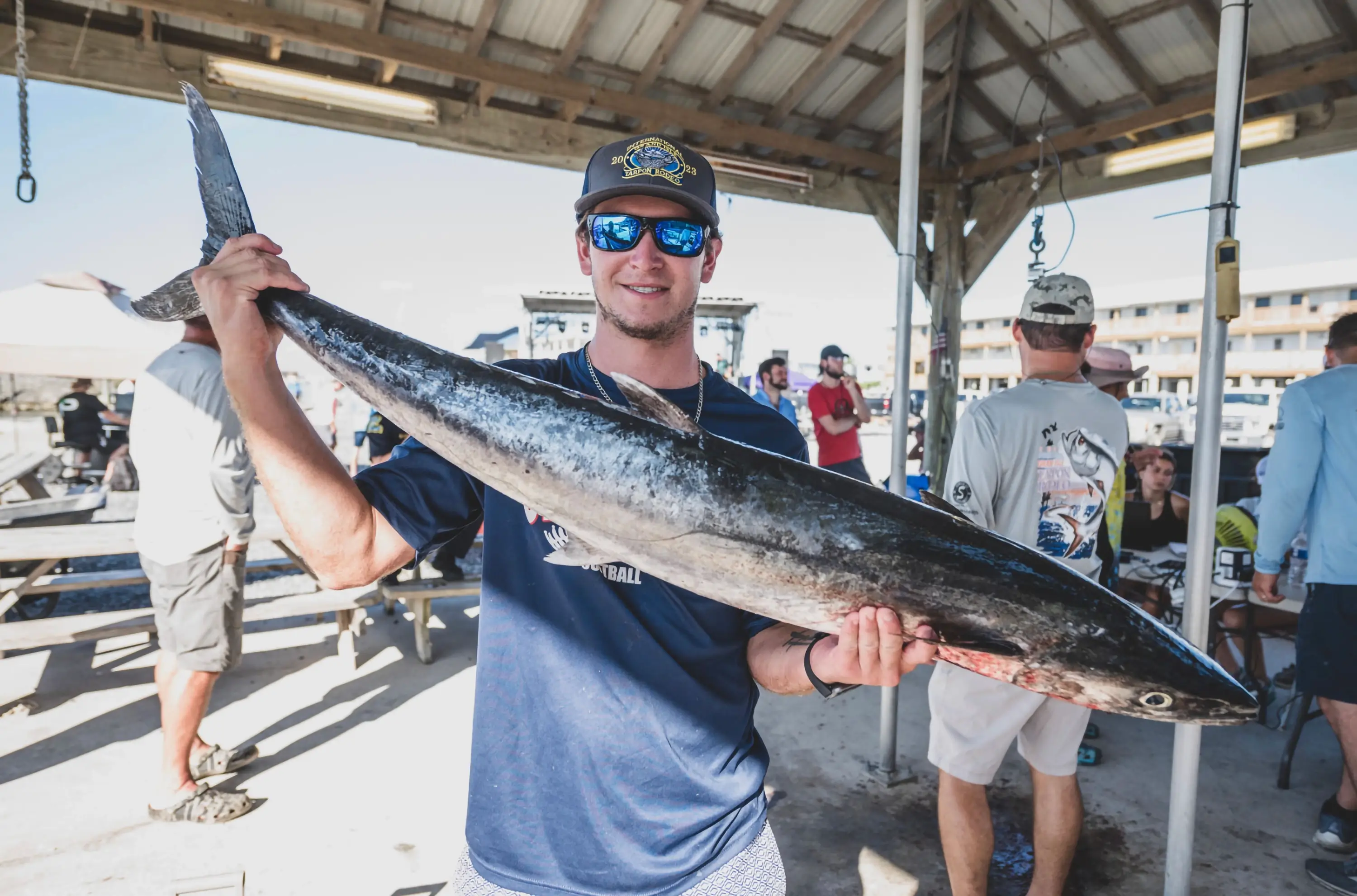A man holding a fish at the Tarpon Rodeo